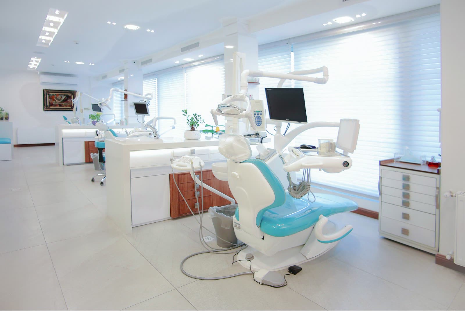 Wide view of a modern dental operatory with wood cabinets