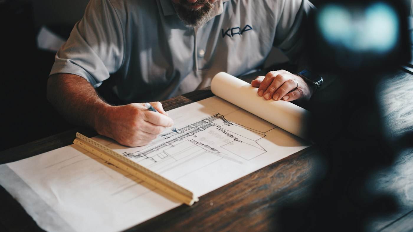 Architectural drawings and a pencil on a desk